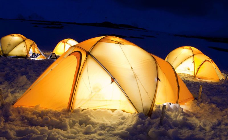 antarctic camping on ice tents lit up at night oc