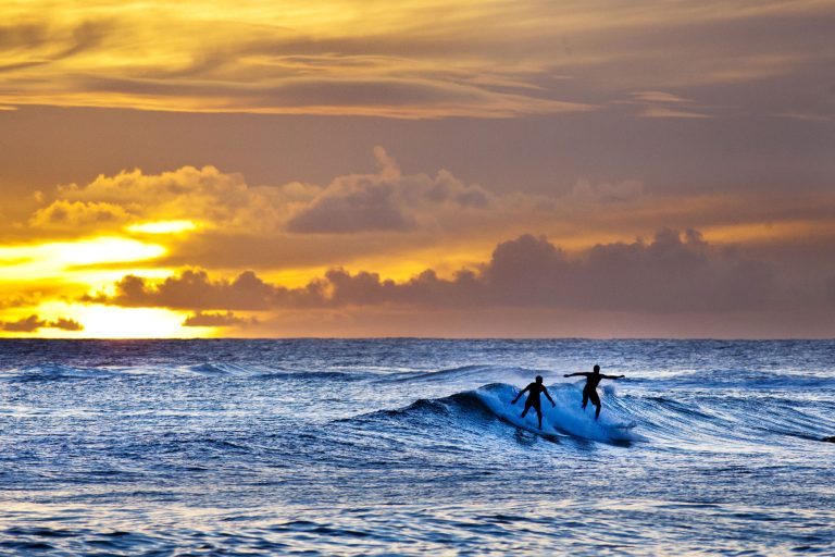 hawaii kauai poipu beach sunset surfers istk