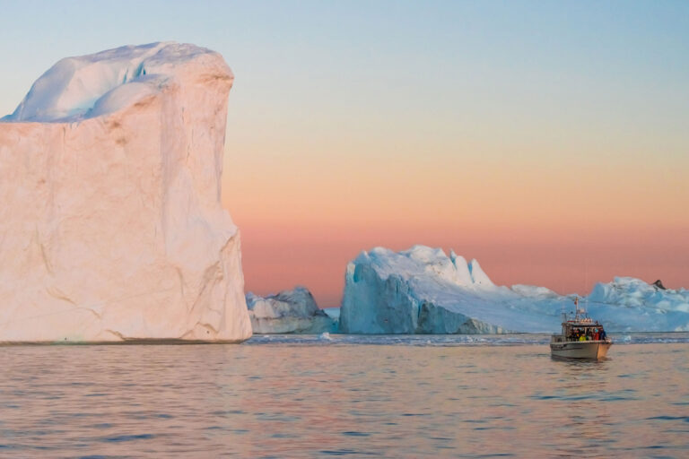 west greenland ilulissat iceberg dwarfs boat istk