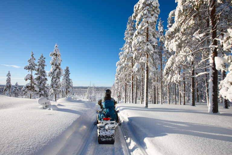 finland lapland snowmobile taiga sunshine istk