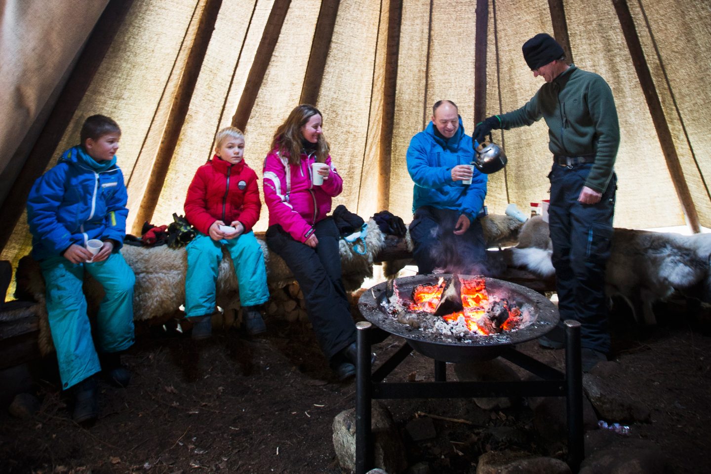 sweden varmland winter family at campfire in lavvu wtrwld