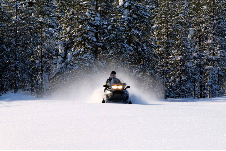 finnish lapland iso syote snowmobile with trees