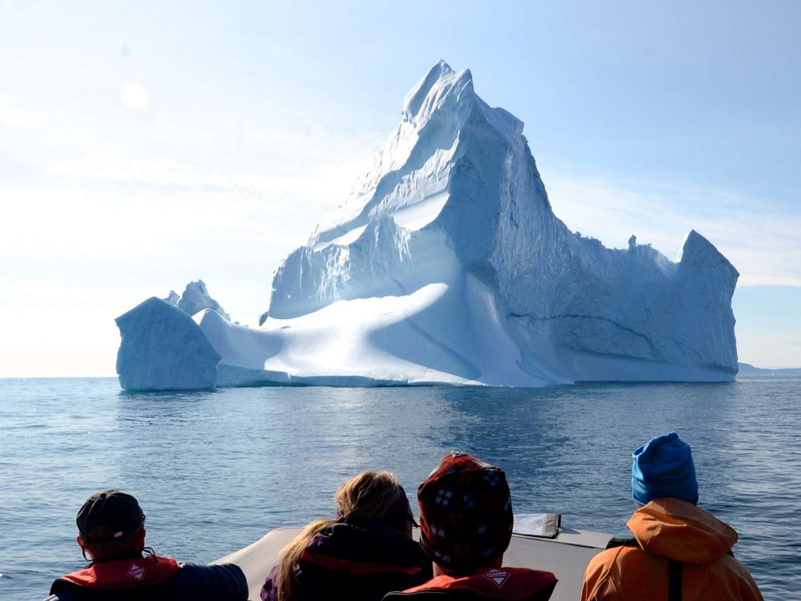east greenland group on boat with iceberg ahead ch