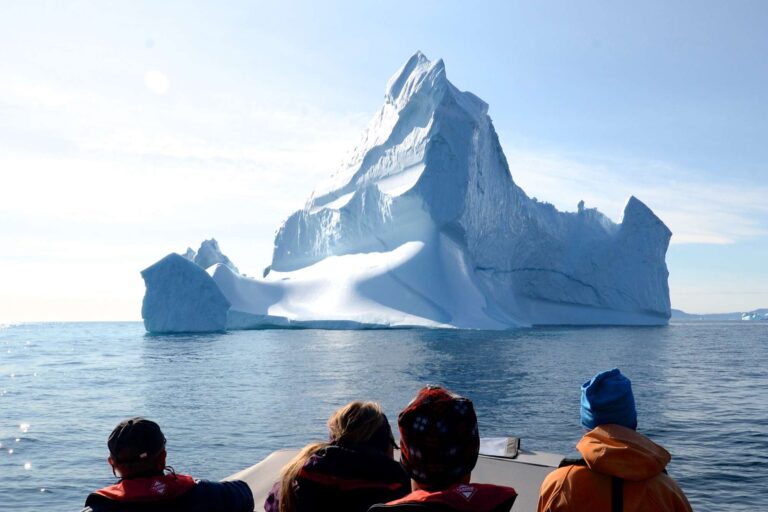 east greenland group on boat with iceberg ahead ch