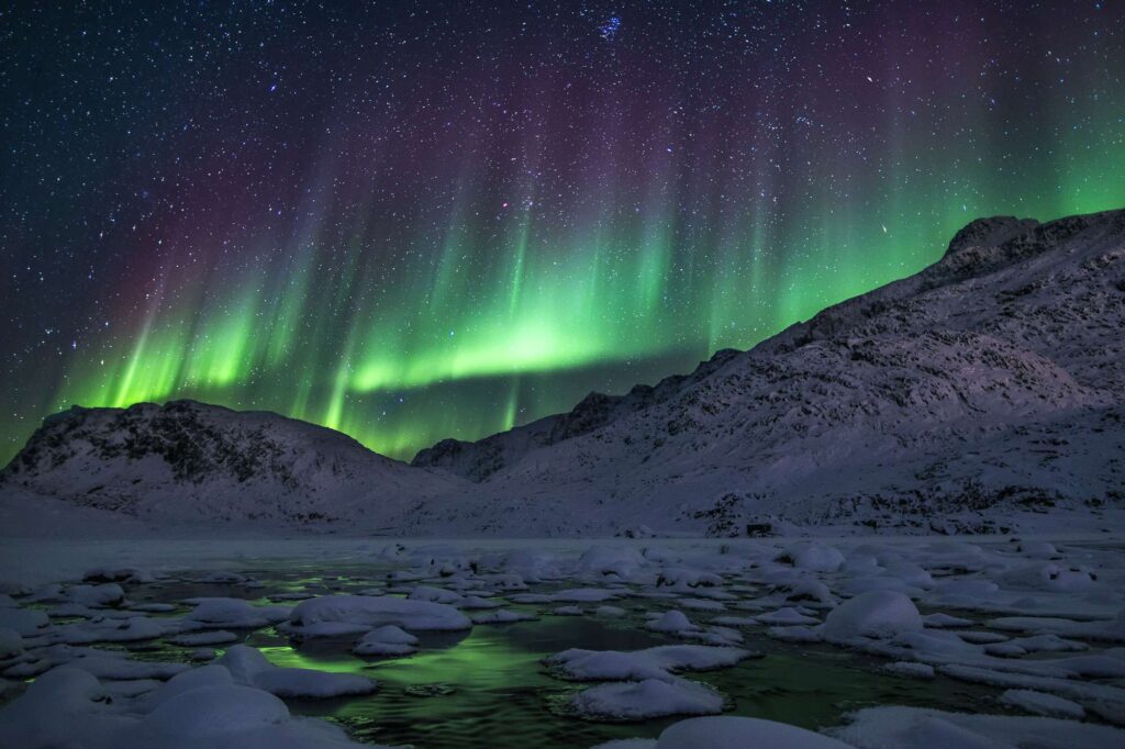 greenland northern lights over ice filled fjord