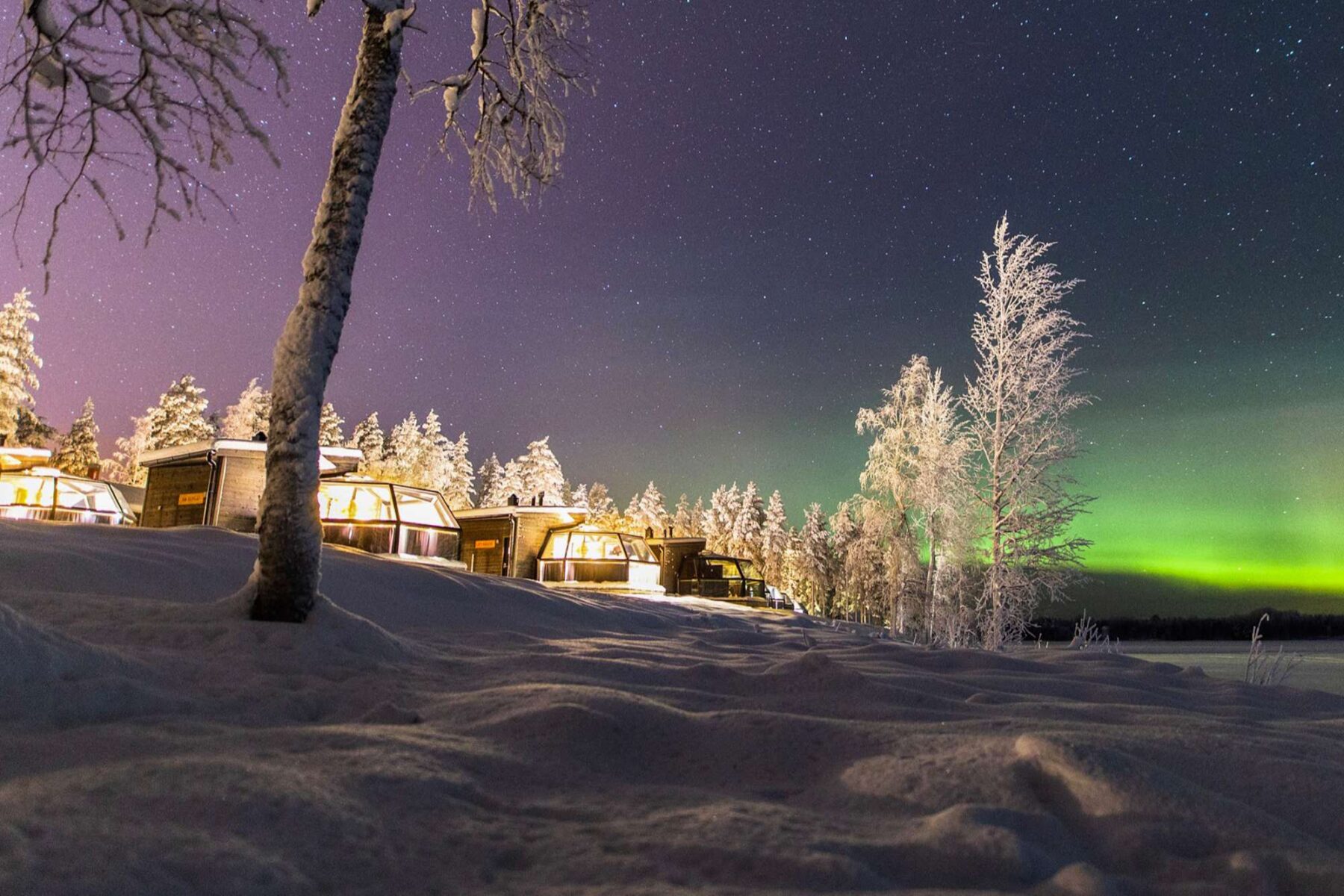finnish lapland ranua arctic glass igloo row aurora sky