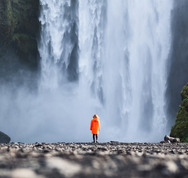 Woman in front of waterfall