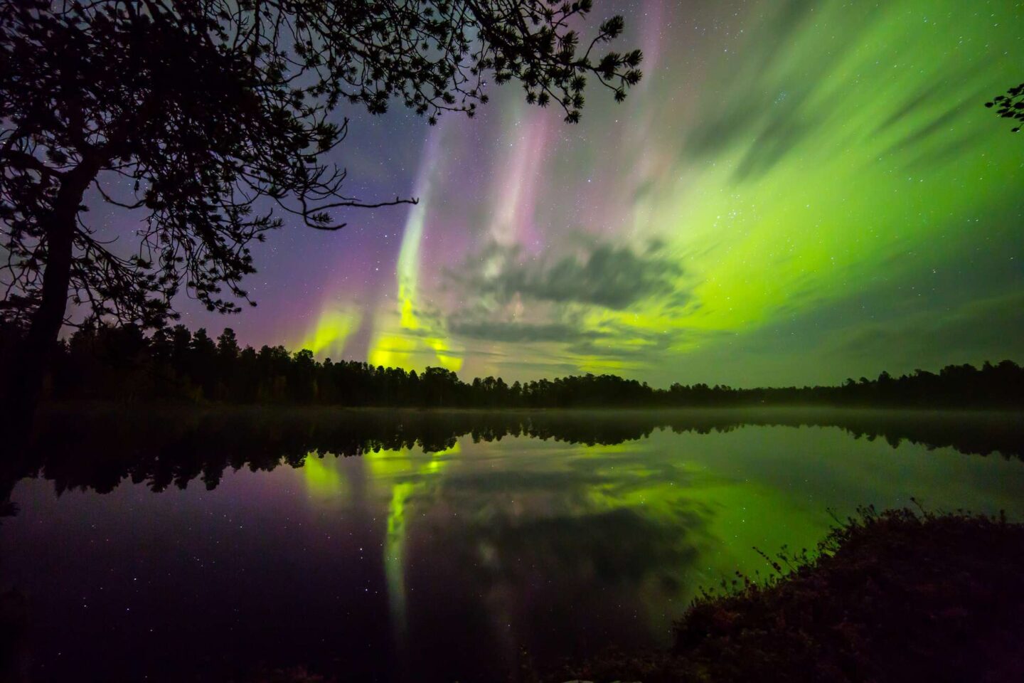 finnish lapland northern lights reflected in lake nellim
