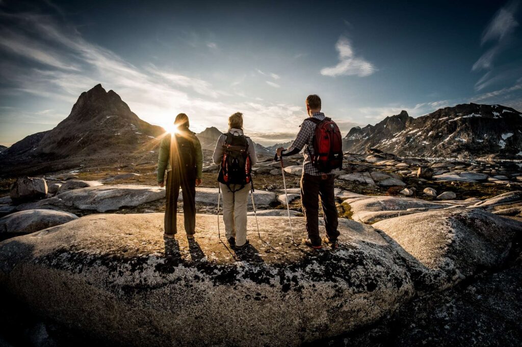 east greenland hikers admiring view vg
