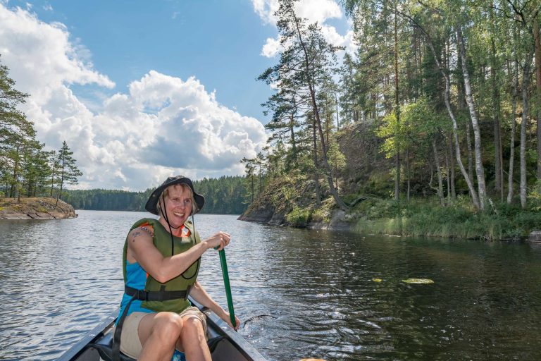 finland woman canoeing on lake istk