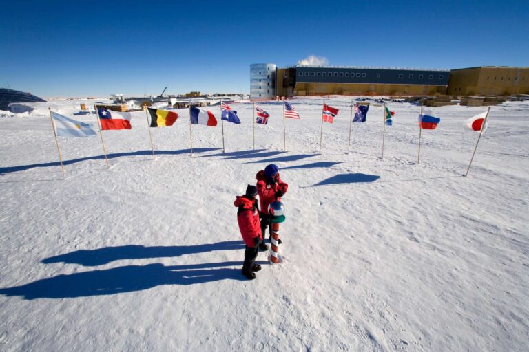 antarctica standing at south pole marker ani