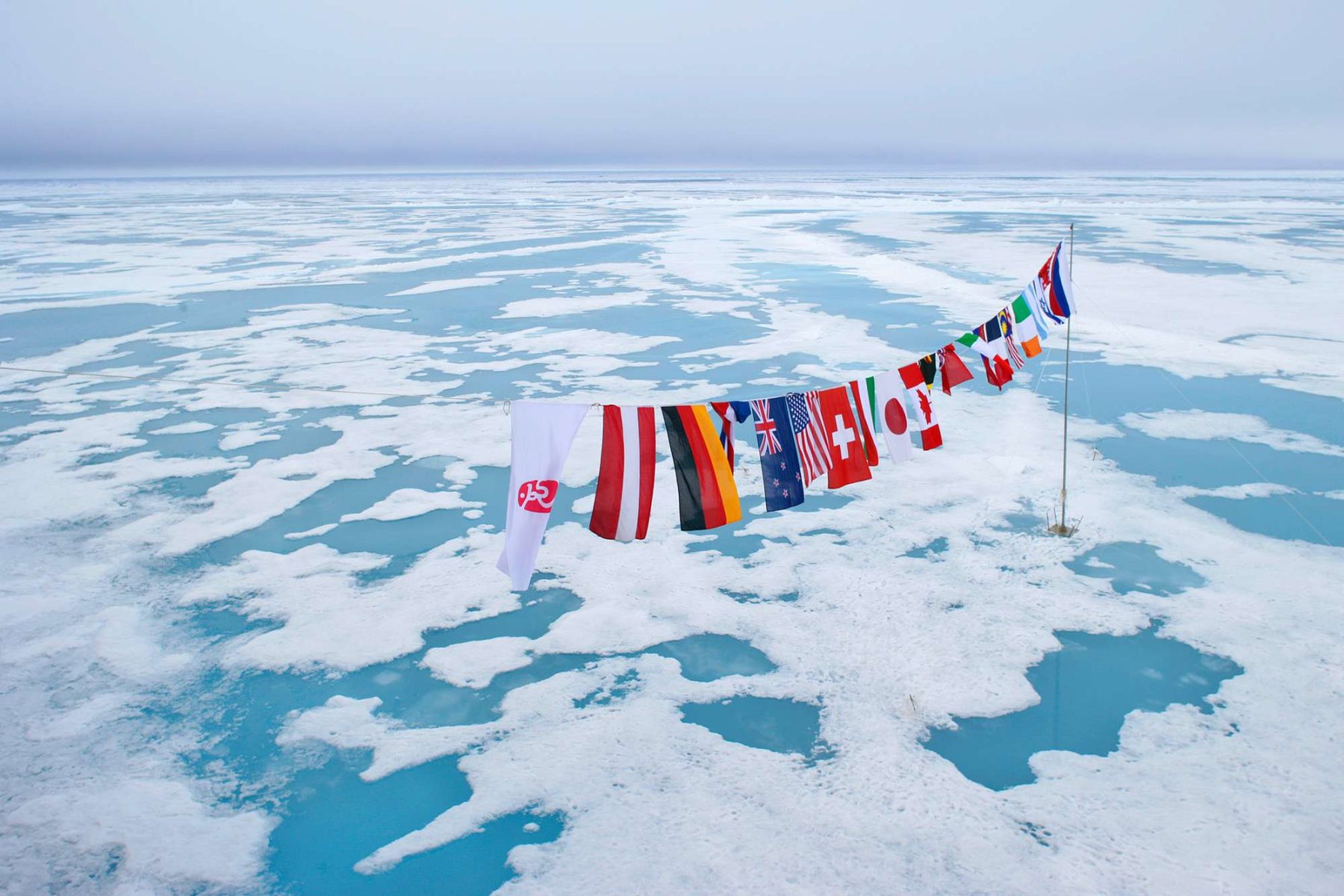arctic multi nation flags at north pole qe