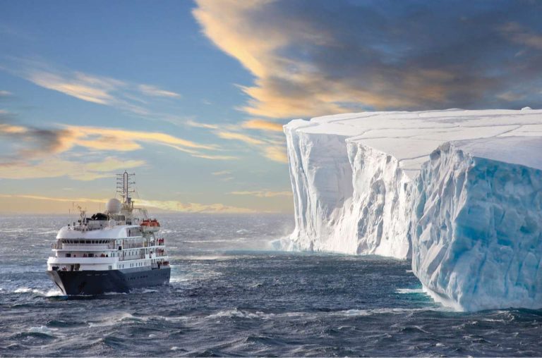 sea spirit cruising past vast iceberg pos