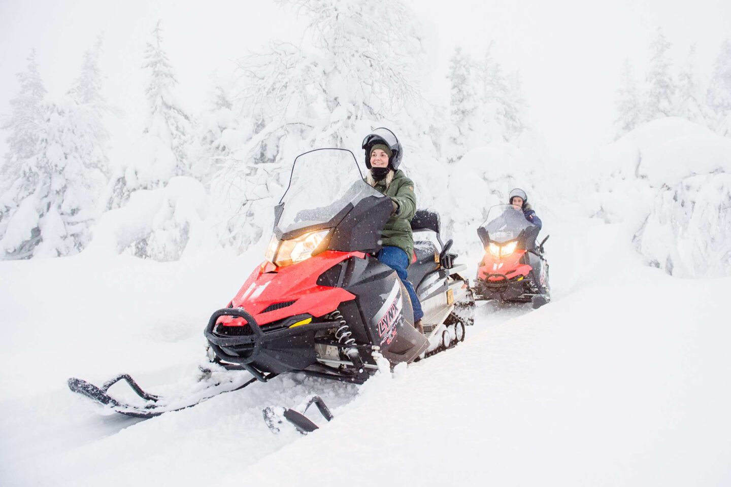 finnish lapland snowmobiling through snowy forest vf