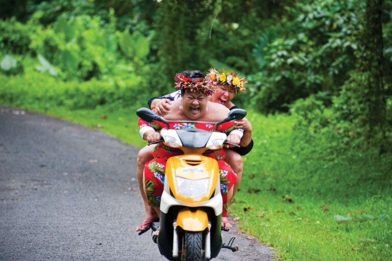 cook islands local woman enjoying a scooter ride cit