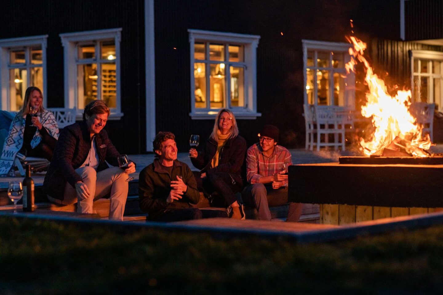 iceland skalakot country manor group around outdoor firepit