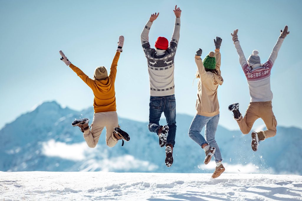 group of people having fun in snow astk