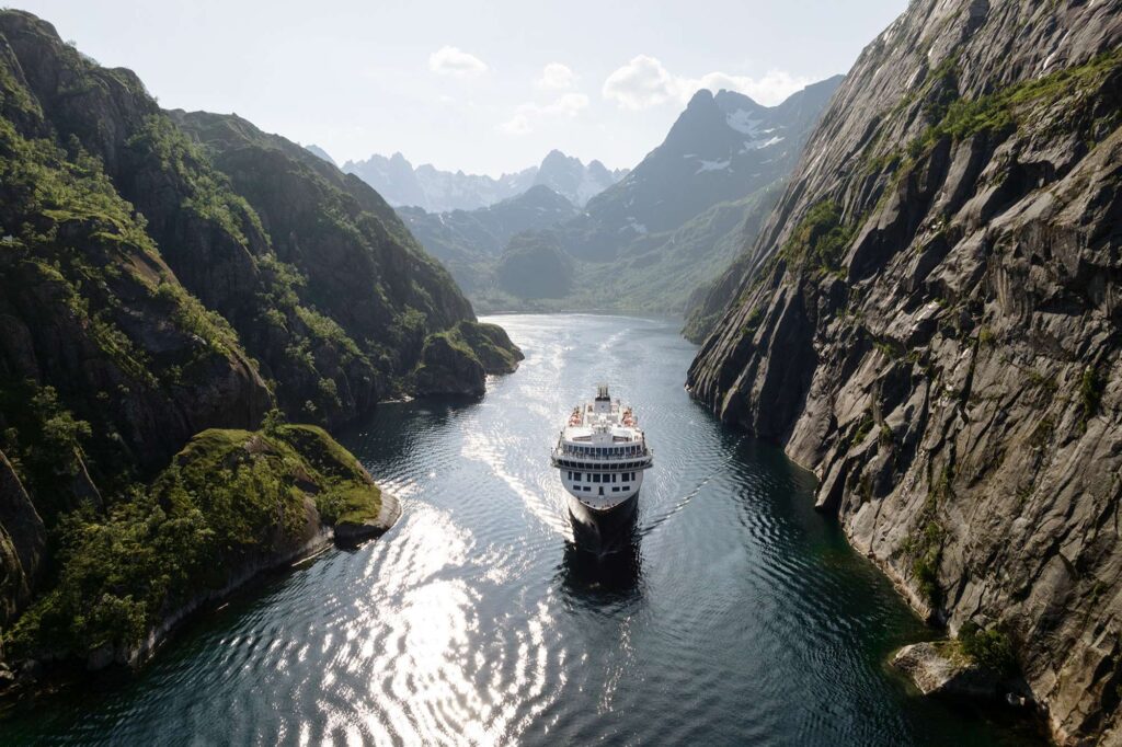 norway cruising through narrow fjord lofoten havila