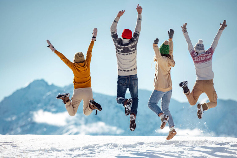 happy-group-of-friends-fun-in-snow-astk