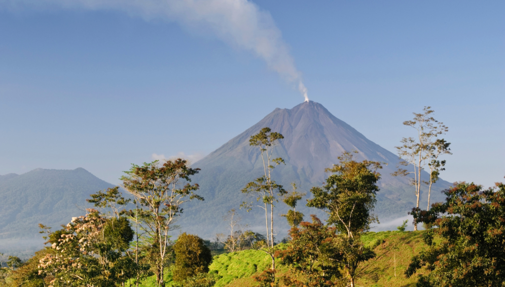 Picture of arenal volcano in costa rica with rainforest in the front