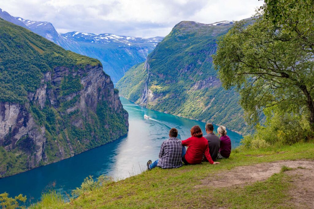 norway couples admiring geirangerfjord istk