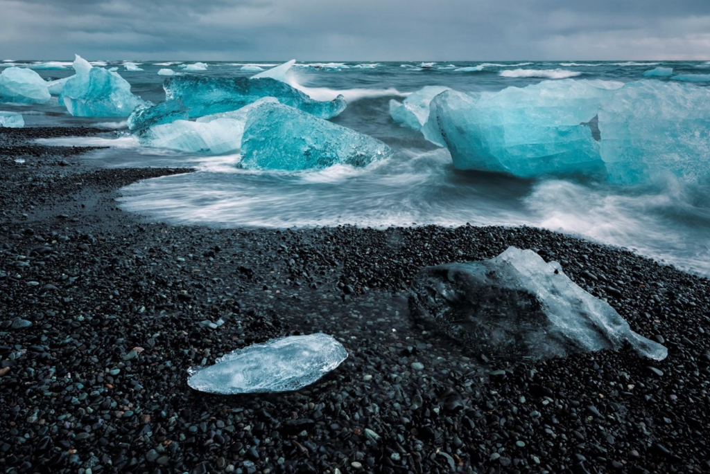 Picture of diamond beach in Iceland with ice washed up on the black sand from the ocean