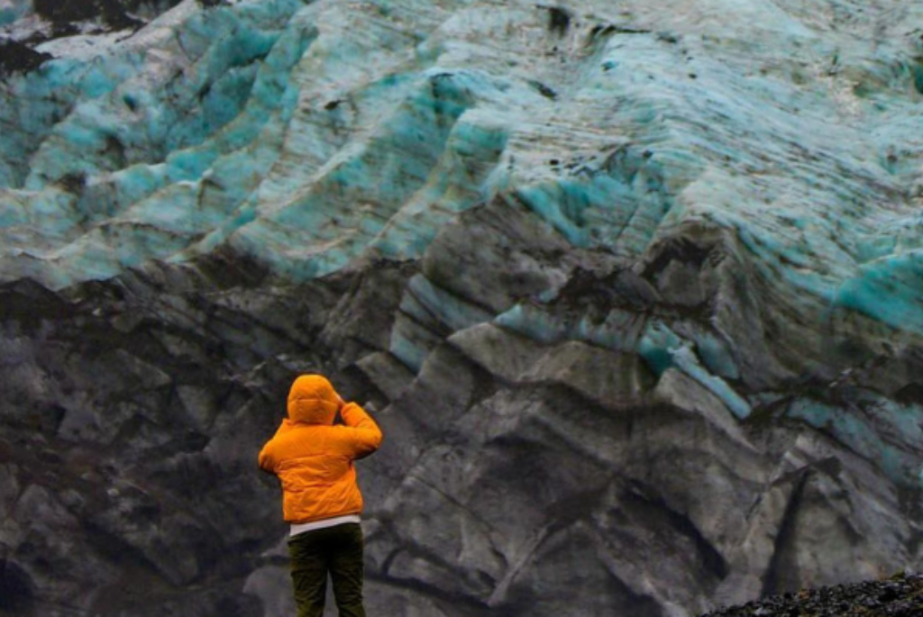 Picture of person standing in front of glacier